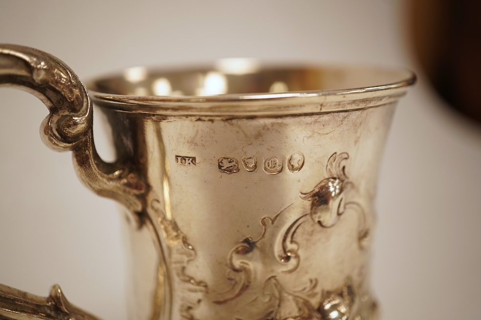 A Victorian embossed silver christening mug, of waisted form, by John Keith, London, 1851, height 10.2cm, 5.8oz.